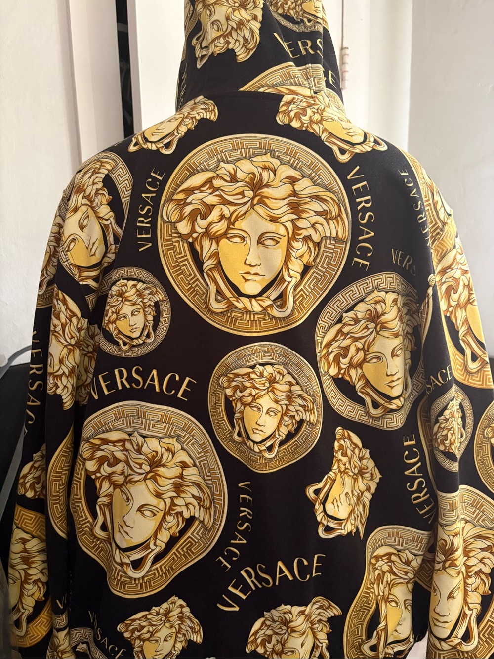 Versace black and gold jacket with hoodie. In excellent condition. Authentic.